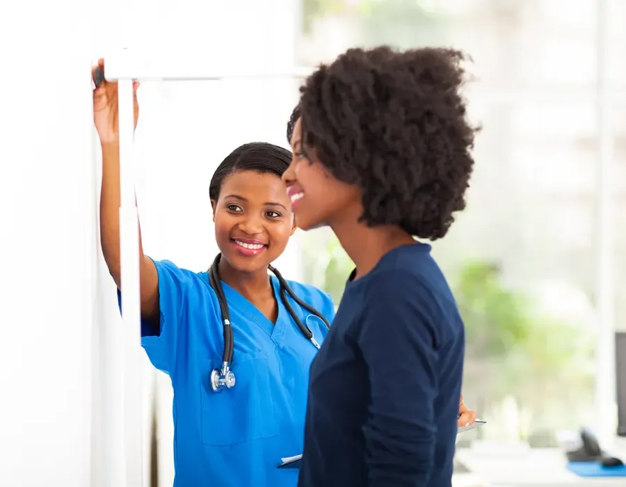 Medical Assistant Helping Patient in Clinic